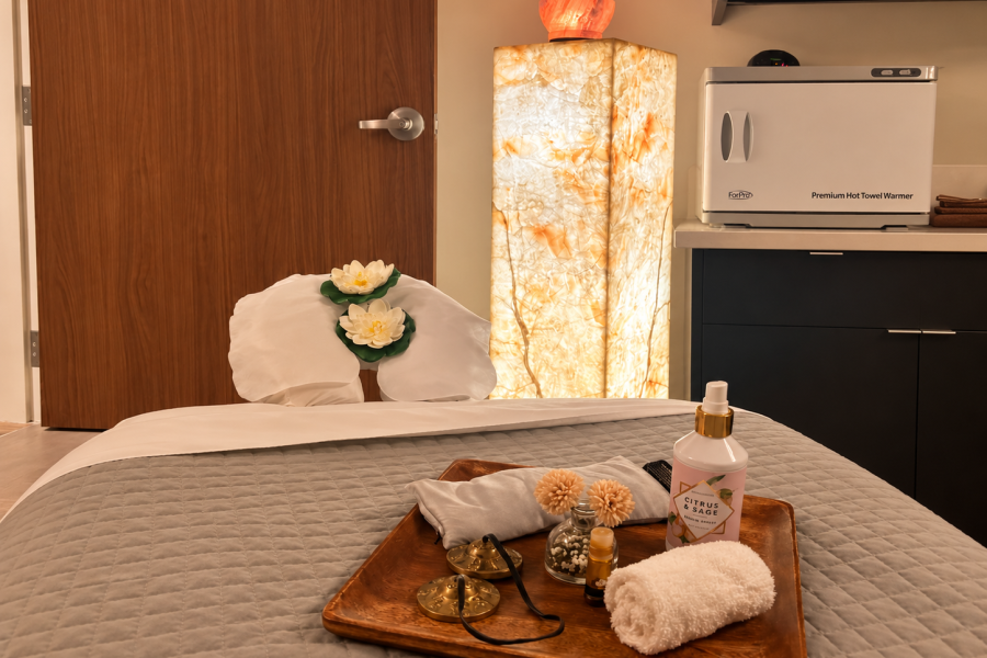 DE SUAR Santa Cruz treatment room inside Courtyard by Marriott with a prepared massage table and illuminated stone column